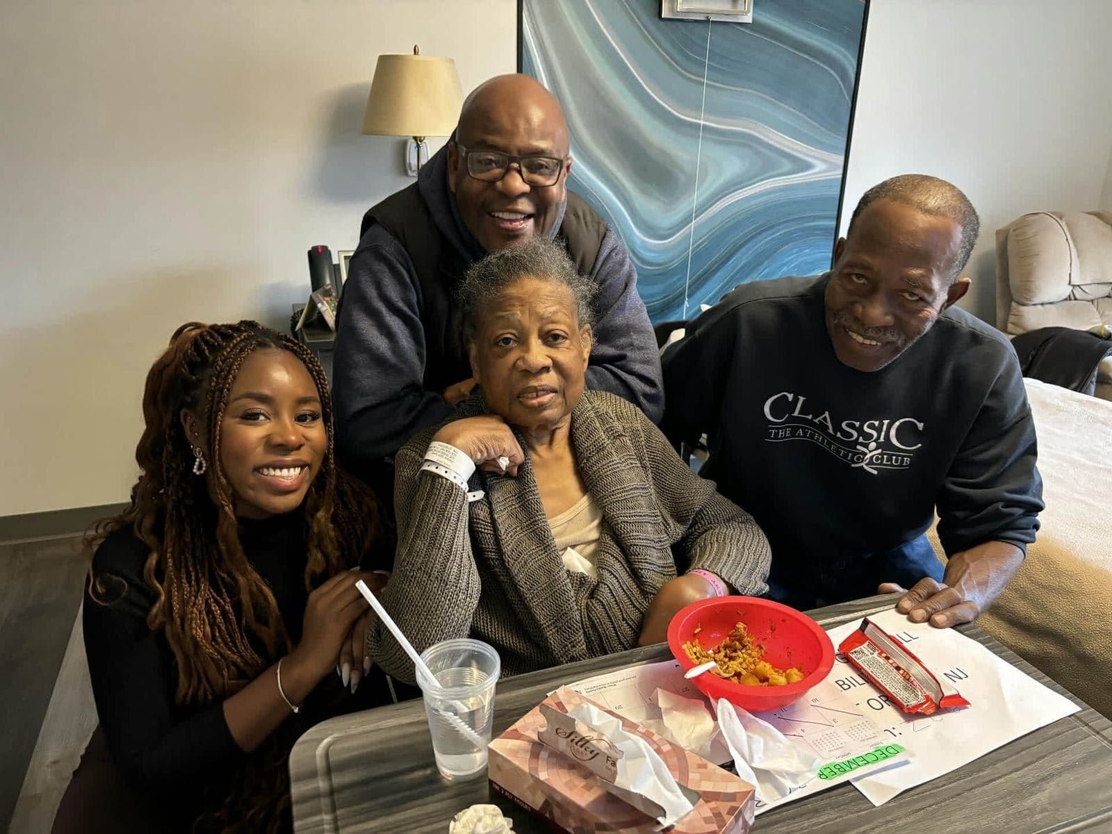 Alex with family gathered around a table