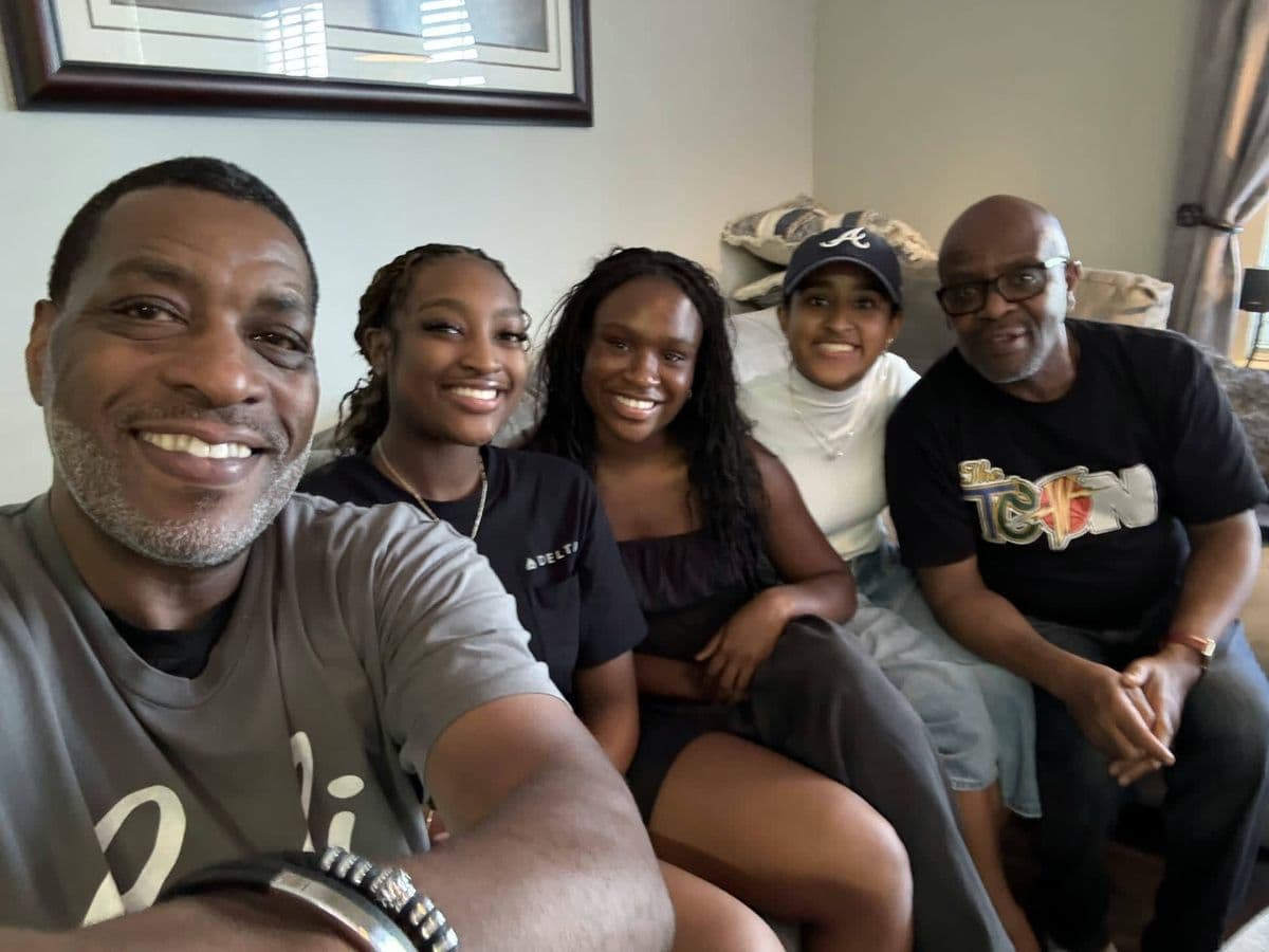 Alex with family and friends, group photo indoors