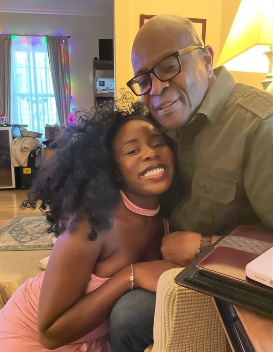 Alex and a loved one in a warm embrace on the couch at home