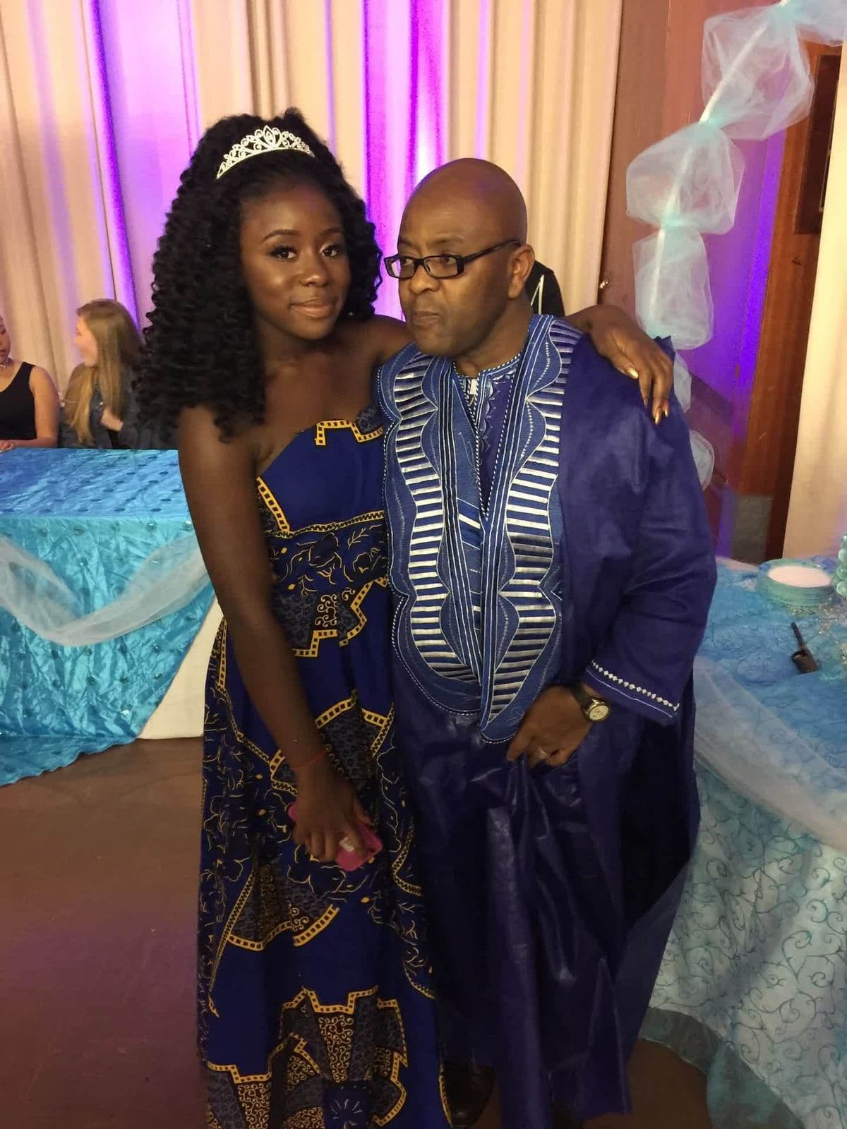 Alex with his daughter in matching blue African attire
