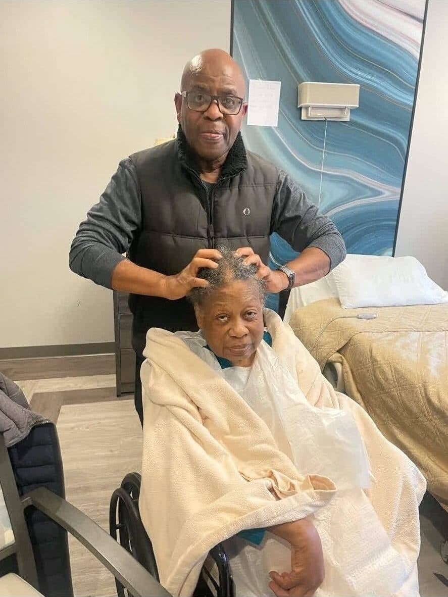 Alex tenderly with an elderly woman in a wheelchair