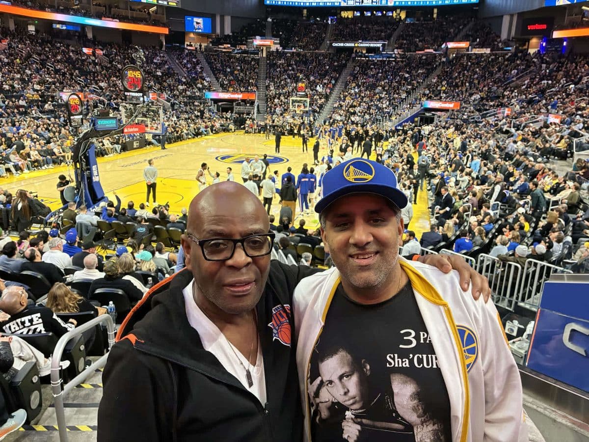 Alex with a friend at a Warriors basketball game