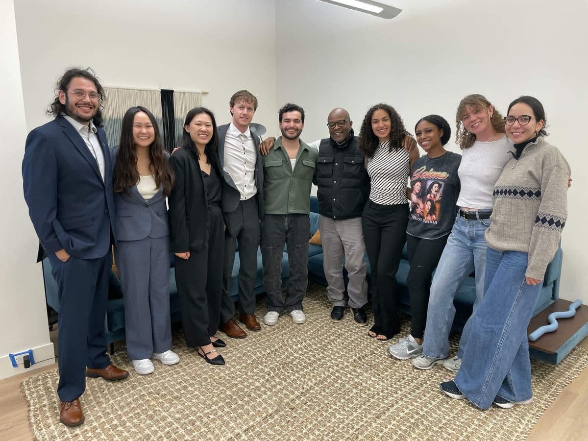 Alex at the center of a large group photo, about ten people