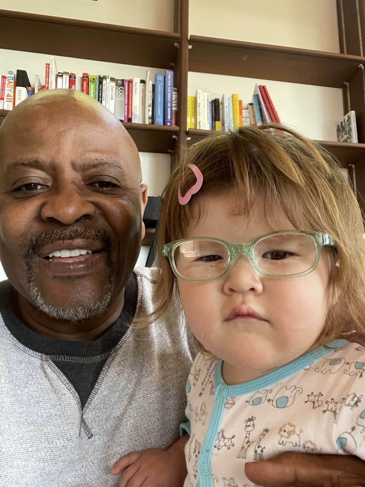 Alex with a young child, close-up selfie, big smiles