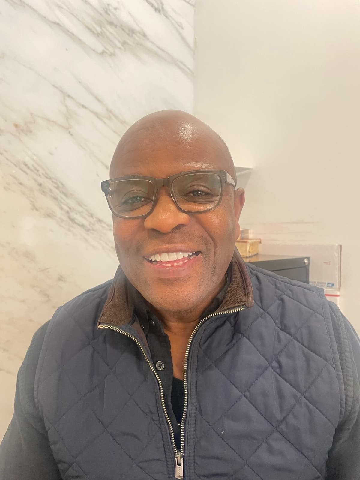 Alex Lewis smiling warmly, DJ Afrique portrait